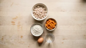 Plain cooked chicken, mashed sweet potato, oat flour, egg, and water for homemade Yorkie treats.